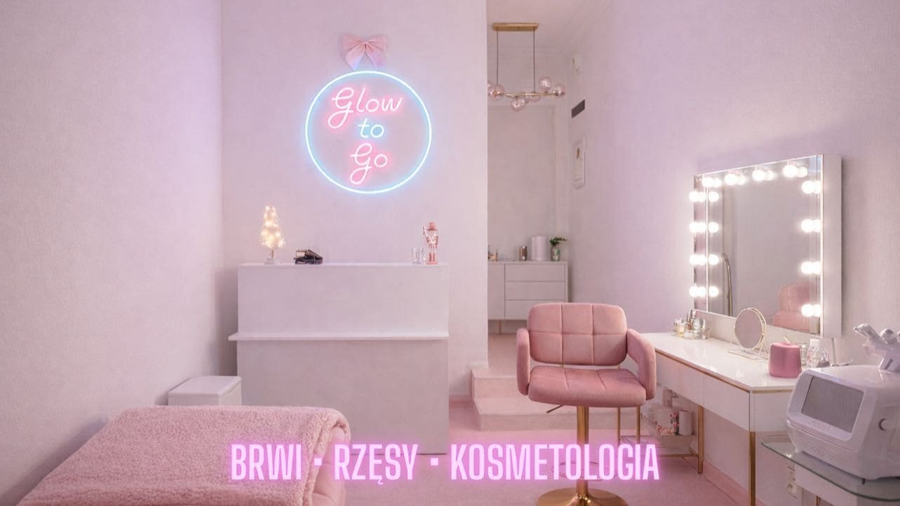 Inside the Glow To Go salon: the “Glow to Go” neon sign on a pink wall, the reception desk, a pink chair and a mirror vanity